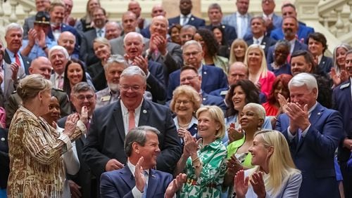 Gov. Brian Kemp on Tuesday signed a $36 billion fiscal 2025 at the Capitol surrounded by lawmakers. (John Spink/ AJC)
