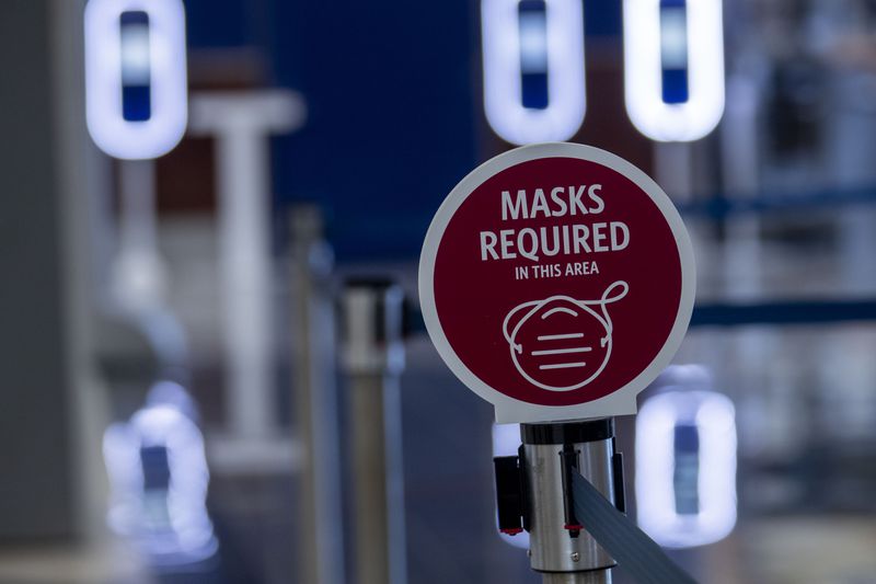 A sign requiring customers to wear masks is displayed at the Delta Air Lines ticket counter line at Hartsfield-Jackson Atlanta International Airport, Friday, September 4, 2020. (Alyssa Pointer / Alyssa.Pointer@ajc.com)
