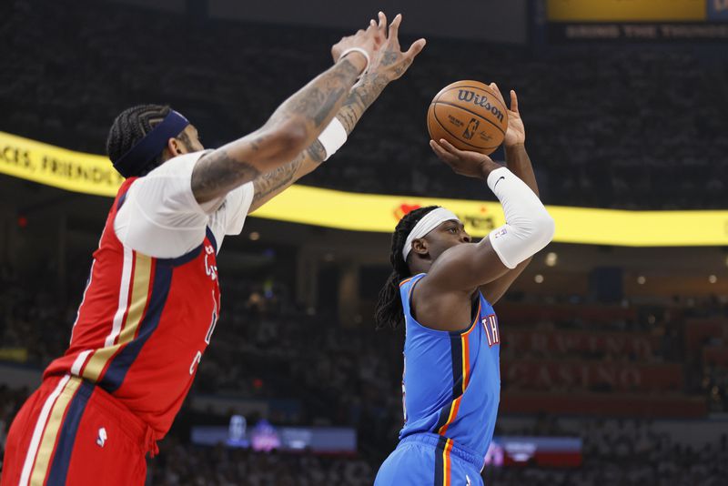 Oklahoma City Thunder guard Luguentz Dort, right, prepares to shoot next to New Orleans Pelicans forward Brandon Ingram during the first half in Game 2 of an NBA basketball first-round playoff series Wednesday, April 24, 2024, in Oklahoma City. (AP Photo/Nate Billings)