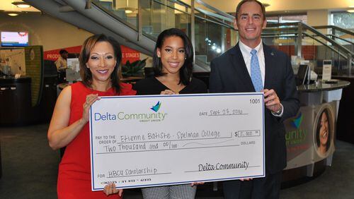 Etienne with KISS 104 radio personality Veronica Waters and Delta Community Credit Union CEO Hank Halter.