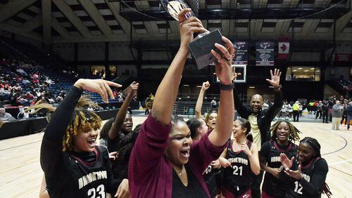 Brookwood's head coach Courtney Mincy holds up the championship trophy during 2023 GHSA Basketball Class 7A Girl’s State Championship game at the Macon Centreplex, Saturday, March 11, 2023, in Macon, GA. (Hyosub Shin / Hyosub.Shin@ajc.com)