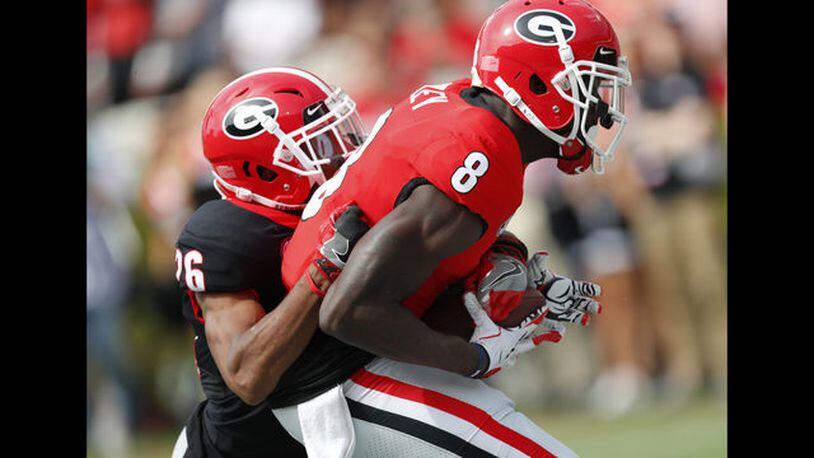 Georgia wide receiver Trey Blount (14) and defensive back D"Andre Walker battle fro the ball during the first half of the G day intrasquad spring college football game Saturday, April 21, 2018, in Athens, Ga. (AP Photo/John Bazemore)