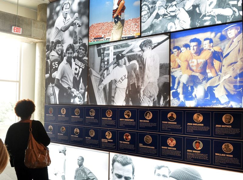 In this 2014 file photo, attendees look at exhibits at the College Football Hall of Fame. KENT D. JOHNSON / KDJOHNSON@AJC.COM