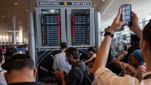 
                        Travellers check the status of the flights at Ben Gurion International Airport outside Tel Aviv on Tuesday, Oct. 10, 2023. Flight disruptions to and from Tel Aviv continue on Tuesday. (Tamir Kalifa/The New York Times)
                      