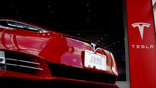 A Tesla electric vehicle sits in the new dealership at the Avalon development in Alpharetta. The Tesla-owned retail store, which opened April 27, 2016, is the fourth of only five the company is allowed by law in Georgia. TAYLOR CARPENTER / TAYLOR.CARPENTER@AJC.COM