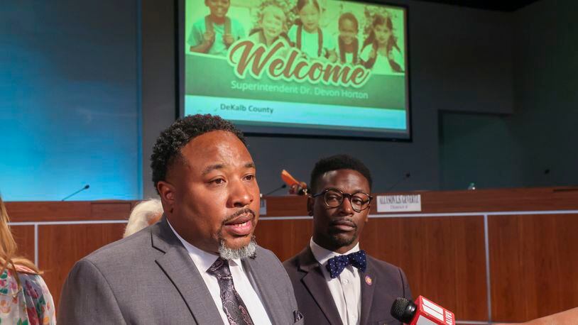 With a welcome sign in the background, Devon Horton talks with members of the media after the DeKalb County Board of Education hired Horton for the superintendent position at the DeKalb County Administrative Center, Wednesday, April 19, 2023, in Stone Mountain, Ga. Also pictured is chair Diijon DaCosta, right. (Jason Getz / Jason.Getz@ajc.com)