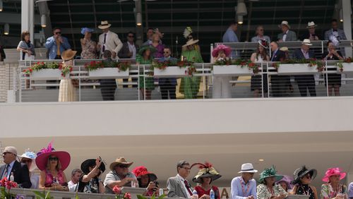 Race fans watch the paddock at Churchill Downs before the 150th running of the Kentucky Derby horse race Saturday, May 4, 2024, in Louisville, Ky. (AP Photo/Brynn Anderson)