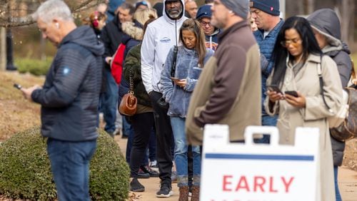 Voters wait in line at Milton Library in Milton on the last day of early voting in December 2022. (Arvin Temkar / arvin.temkar@ajc.com)
