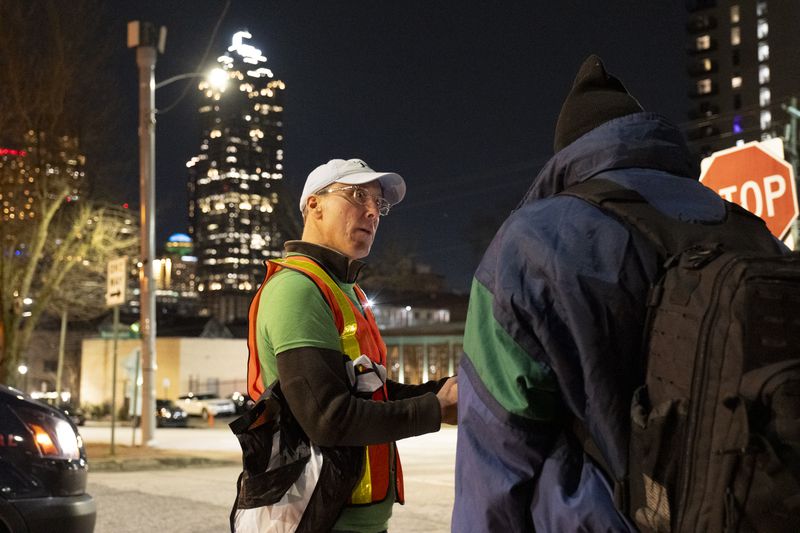 Erik Johnson interviews a man during a “point-in-time” count of people experiencing homelessness in Atlanta on Monday, Jan. 22, 2024.   (Ben Gray / Ben@BenGray.com)