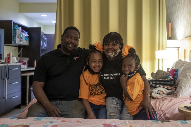 Edward Mitchell and his wife Brittany Mitchell, with their daughters Runyia McKiver, center and Brooklyn Mitchell, right, have lived in a series of hotels since the tornado left their house unlivable. (Alyssa Pointer / Alyssa.Pointer@ajc.com)
