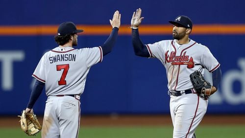 Dansby Swanson and Matt Kemp celebrate a 3-1 win over the New York Mets in the 12th inning on April 5, 2017, at Citi Field in New York City.