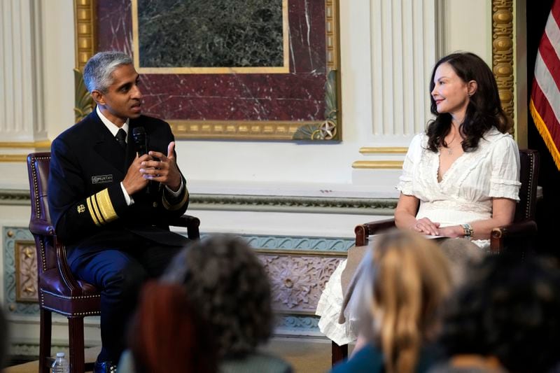 Surgeon General Dr. Vivek Murthy, left, sitting next to Ashley Judd, right, speaks during an event on the White House complex in Washington, Tuesday, April 23, 2024, with notable suicide prevention advocates. The White House held the event on the day they released the 2024 National Strategy for Suicide Prevention to highlight efforts to tackle the mental health crisis and beat the overdose crisis. (AP Photo/Susan Walsh)