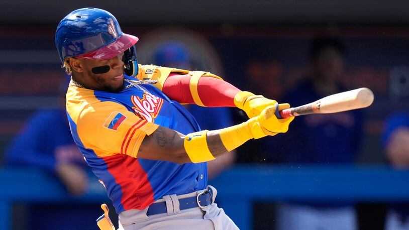Venezuela's Ronald Acuna Jr. follows through on a single during the fifth inning of an exhibition baseball game against the New York Mets, Thursday, March 9, 2023, in Port St. Lucie, Fla. (AP Photo/Lynne Sladky)