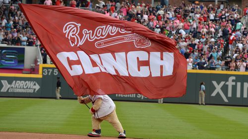 The Atlanta Braves mascot Blooper, waves a flag after the Braves clinched  their division with a win over the Philadelphia Phillies at SunTrust Park on Saturday, Sept. 22, 2018.