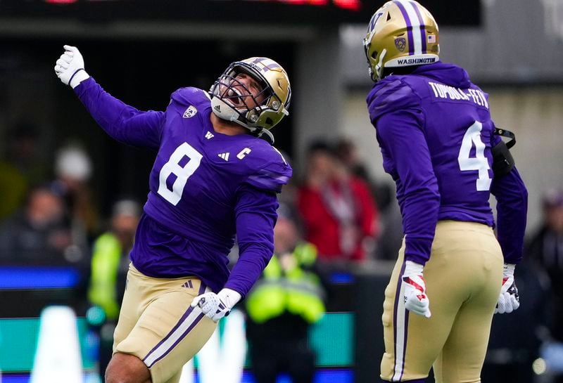 Washington defensive end Bralen Trice (8) celebrates a sack against Utah as defensive end Zion Tupuola-Fetui (4) looks on during the first half of an NCAA college football game Saturday, Nov. 11, 2023, in Seattle. (AP Photo/Lindsey Wasson)