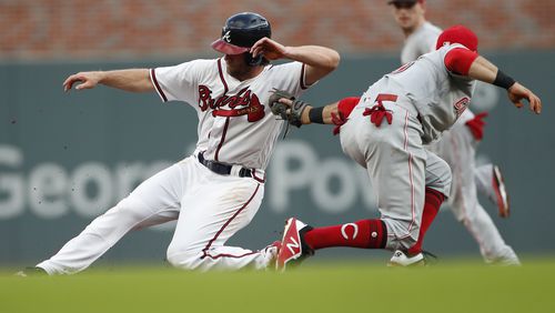 The Braves’ Charlie Culberson slides past the tag of Reds shortstop Jose Peraza for a second-inning stolen base Tuesday night. (AP Photo/John Bazemore)