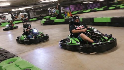 Kadri Ozee leads Holly Pourhassan down the straight away at Andretti Karting & Games in Marietta.