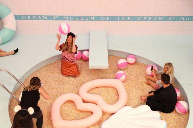 Guests enjoy the sprinkle pool at Museum of Ice Cream opening party on September 15, 2017 in San Francisco, California.  (Photo by Kelly Sullivan/Getty Images for Museum of Ice Cream)