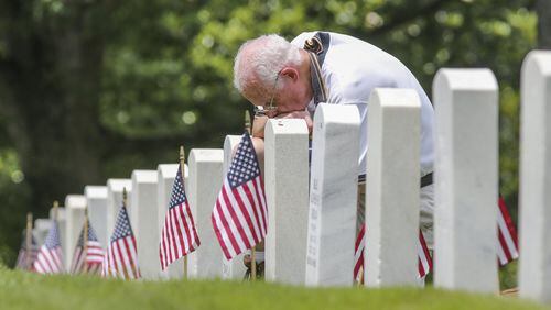 Dale Covington of Marietta, a Vietnam veteran, prays at the end of Maj. Gen. Joe Jarrard’s address at the 2017 Memorial Day Ceremony at the Marietta National Cemetery.