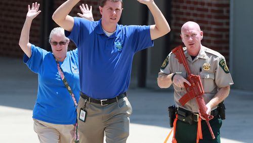 July 25, 2018 Winston: A law enforcement officer helps evacuate teachers and students during an active shooter training exercise held by the Douglas County Sheriff's Office at Mason Creek Middle School on Wednesday, July 25, 2018, in Winston. The large scale training drill is meant to test the resources of area law enforcement and emergency responders in an effort to better prepare Douglas County First Responders in the event of a mass casualty active shooter event.   Curtis Compton/ccompton@ajc.com