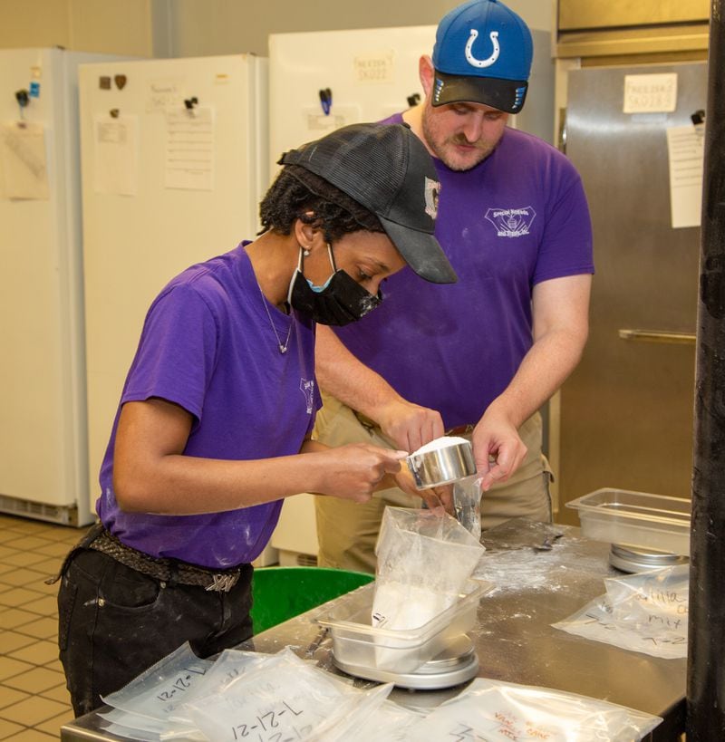 Raven Davis and Bradley Kohler measure out cake flour at Special Kneads and Treats, a bakery in Lawrenceville that employs only special needs individuals. The bakery is on a mission to raise $100,000 in six months. They were given the challenge this spring by a local benefactor who said if they raise that much, he will match the $100k, allowing Tempa and Michael Kohler (the owners) to pay off the shop's mortgage.  PHIL SKINNER FOR THE ATLANTA JOURNAL-CONSTITUTION.