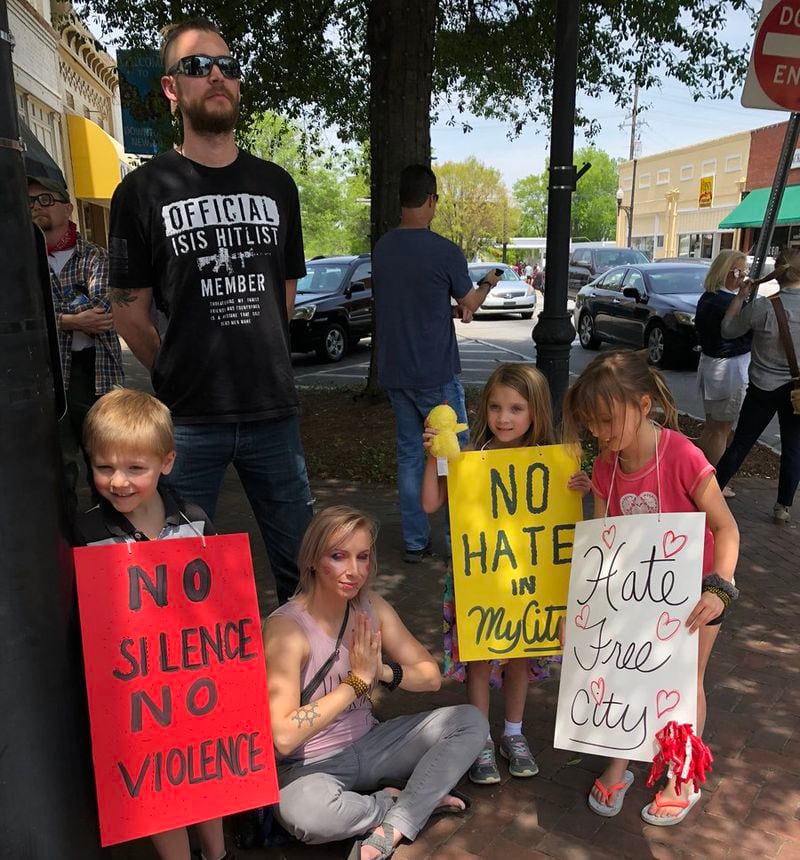 “Fascism has no place in this town,” said Newnan resident Brad Strange, who was on the square with wife Ashley and their three kids.