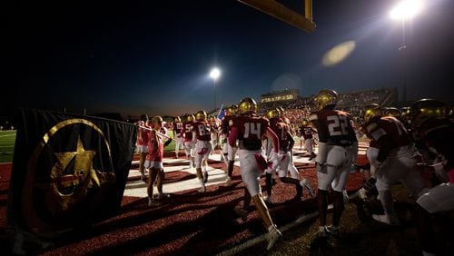 The Johns Creek Gladiators take the field during a GHSA high school football game between Cambridge High School and Johns Creek High School in Johns Creek, Ga. on Friday, October 15, 2021. (Photo/Jenn Finch)