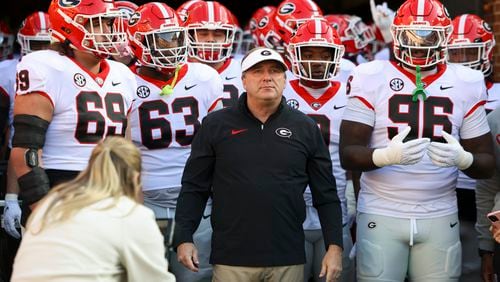 Georgia head coach Kirby Smart walks out with Georgia offensive lineman Tate Ratledge (69), offensive lineman Sedrick Van Pran (63) and defensive lineman Zion Logue (96) before their game against Tennessee at Neyland Stadium, Saturday, November 18, 2023, in Knoxville, Tn. (Jason Getz / Jason.Getz@ajc.com)