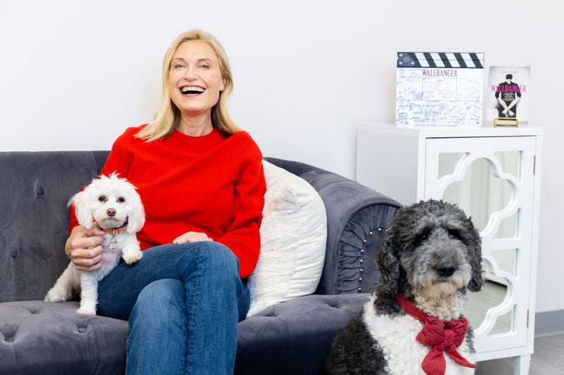 Tosca Musk, CEO of Passionflix, poses for a portrait at the company’s headquarters in Palmetto on Thursday, February 8, 2024. She’s joined by her dog Jane (left) and marketing director Ali Whitaker’s dog Molly (right). (Arvin Temkar / arvin.temkar@ajc.com)