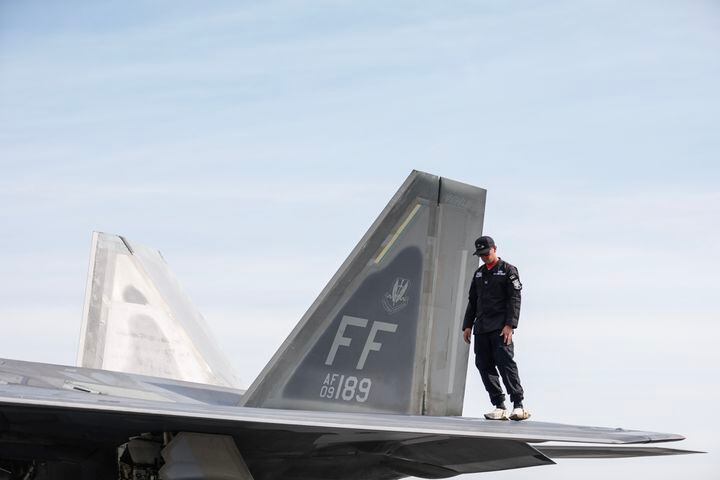 A member of the F-22 Demo Team inspects the jet after landing at Hartsfield-Jackson International Airport on Thursday, October 5, 2023. The F-22 Demo Team will be participating in the 2023 Atlanta Air Show taking place Oct. 7-8 at Atlanta Regional Airport Falcon Field. (Natrice Miller/ Natrice.miller@ajc.com)