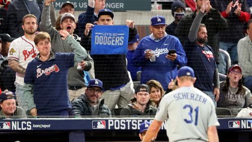 Fans react as Los Angeles Dodgers starting pitcher Max Scherzer (31) is removed from the mound during the fifth inning of Game 2 of the NLCS Sunday, Oct. 17, 2021, at Truist Park in Atlanta. (Curtis Compton / curtis.compton@ajc.com)