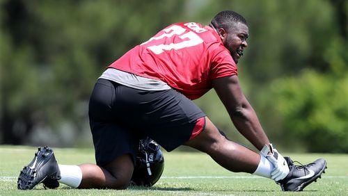 Offensive tackle Matt Gono stretches for the second day of Falcons rookie-mini-camp on Saturday, May 12, 2018, in Flowery Branch.