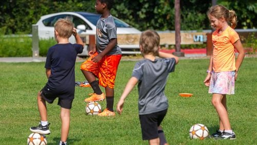 Kids participate in a soccer workout with Soccer Shots at  Historic Fourth Ward Skatepark in Atlanta Sunday, August 01, 2021.STEVE SCHAEFER FOR THE ATLANTA JOURNAL-CONSTITUTION