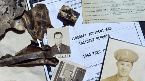 These old photos, documents and airplane shrapnel were collected by Craig Schneider during his search for information about his uncle. HYOSUB SHIN / HSHIN@AJC.COM