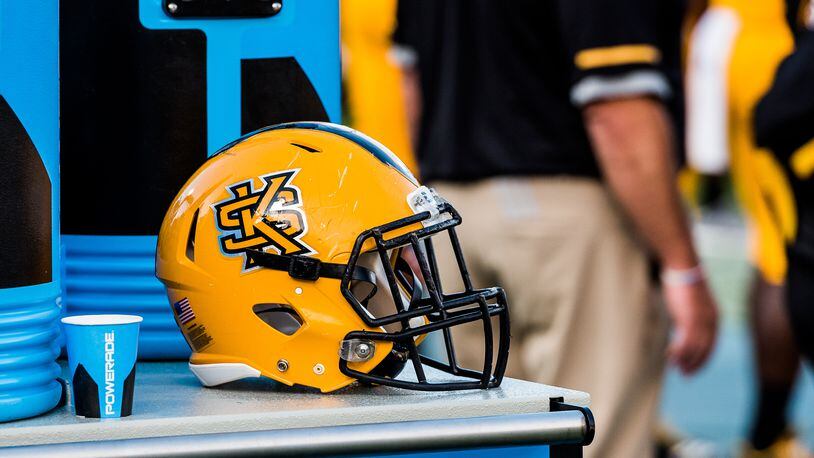 A gold Kennesaw State helmet sits on the sideline. (Special by Cory Hancock)
