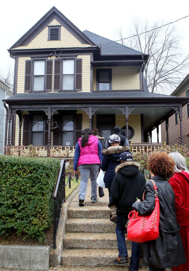 Visitors walk up the front steps of Martin Luther King Jr.’s birth home at the National Historic Site. AJC FILE PHOTO 2013