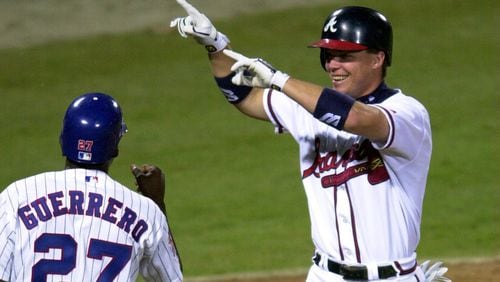 000711 - ATLANTA, GA.: Chipper Jones celebrates his home run with NL teammate Vladimir Guerrero in the third inning Tuesday evening, 7/11/00 at Turner Field in Atlanta in the All-Star Game. (PHOTO BY FRANK NIEMEIR/STAFF)