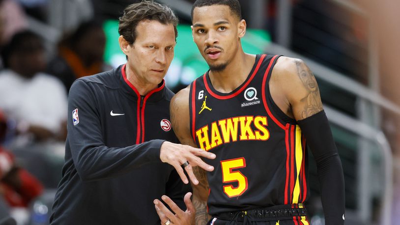 Hawks coach Quin Snyder talks with guard Dejounte Murray on Tuesday during a game against the Wizards. It has been a whirlwind of a week for Snyder, but he hasn’t been timid about stepping into the new role. (Jason Getz / Jason.Getz@ajc.com)