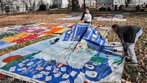 Nina Martinez (left), an AIDS advocate, and Roddy Williams, AIDS Quilt Director of Operations, straighten a section of the AIDS Quilt last December at Emory University.