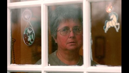 From 1999: Mary Stoner looks out the kitchen window of her home in Adairsville, toward the grave of her daughter Mary Frances Stoner, who is buried out behind the house and up on a hill. Mary Frances was raped and murdered when she was 12 years old old, which at that point was 20 years ago.