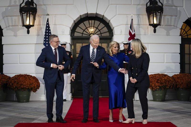 Prime Minister Anthony Albanese of Australia and Jodie Haydon, his partner, figure out their spots for a welcome photo with President Joe Biden and first lady Jill Biden at the White House in Washington, Oct. 24, 2023. (Erin Schaff/The New York Times)