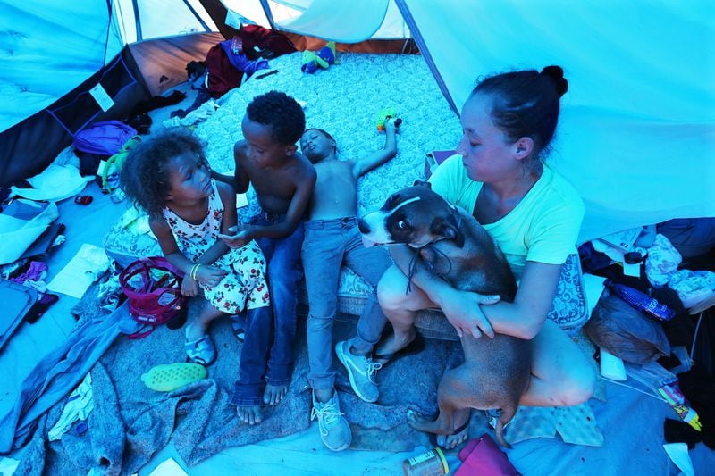  Amanda Bohn of Youngstown, Fla., and her children Nariah, 6, (from left), Dominike, 9, and Isaiah, 8, have been homeless and living in a tent covered with a blue tarp for two months. They’ve been in temporary quarters since March after a landlord put them out of a rented trailer damaged during Hurricane Michael seven months ago, Bohn said. 