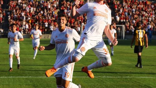 Atlanta United midfielder Andrew Carleton gets some air celebrateing his goal against Charleston Battery with teammate Brandon Vazquez looking on for a 1-0 lead during the first half in a U.S. Open Cup match on Wednesday, June 6, 2018, in Kennesaw.  Curtis Compton/ccompton@ajc.com
