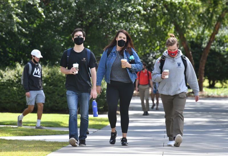In this file photo, students mostly wear face masks as they make their way through the campus at the University of Georgia campus in Athens. (Hyosub Shin / Hyosub.Shin@ajc.com)