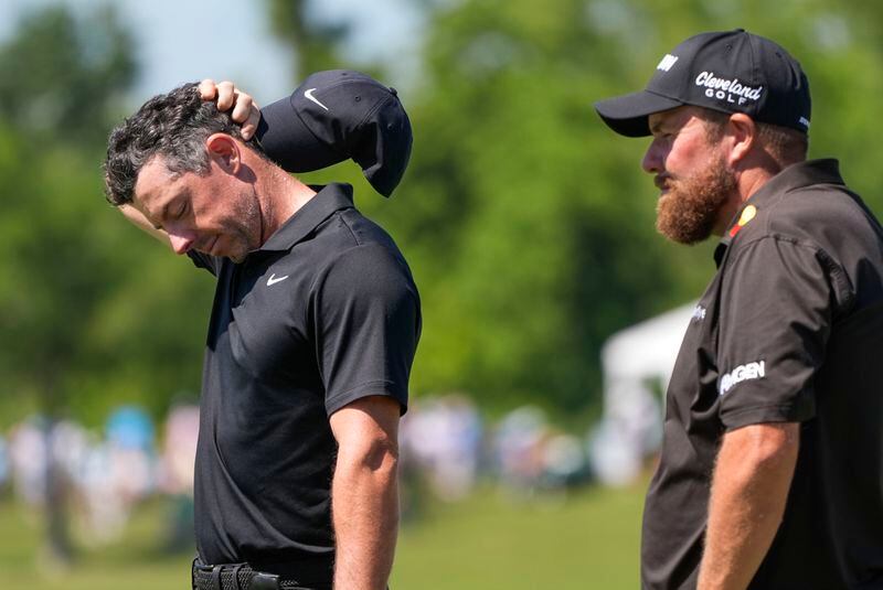 Rory McIlroy, of Northern Ireland, waits his turn on the 18th green with his teammate Shane Lowry, of Ireland, right, during the second round of the PGA Zurich Classic golf tournament at TPC Louisiana in Avondale, La., Friday, April 26, 2024. (AP Photo/Gerald Herbert)