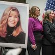 The mother, sister, and brother of slain UGA law student Tara Louise Baker are seen behind a photo of Baker during a press conference announcing an arrest in the 23-year-old cold case death on Monday, May 13, 2024, in Decatur. (Elijah Nouvelage for The Atlanta Journal-Constitution)