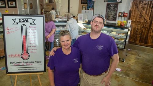 Tempa Koehler (left) stands with her son Bradley at Special Kneads and Treats, a bakery in Lawrenceville that employs only special needs individuals. The bakery is on a mission to raise $100,000 in six months. They were given the challenge this spring by a local benefactor who said if they raise that much, he will match the $100k, allowing Tempa and Michael Kohler (the owners) to pay off the shop's mortgage. PHIL SKINNER FOR THE ATLANTA JOURNAL-CONSTITUTION.