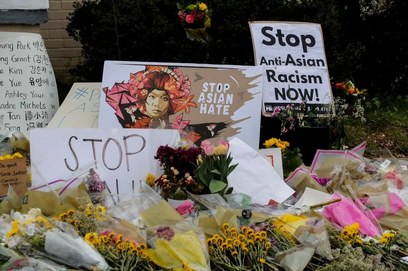 Signs and flowers were left in front of the Gold Spa on Piedmont Road after the 2021 shootings.