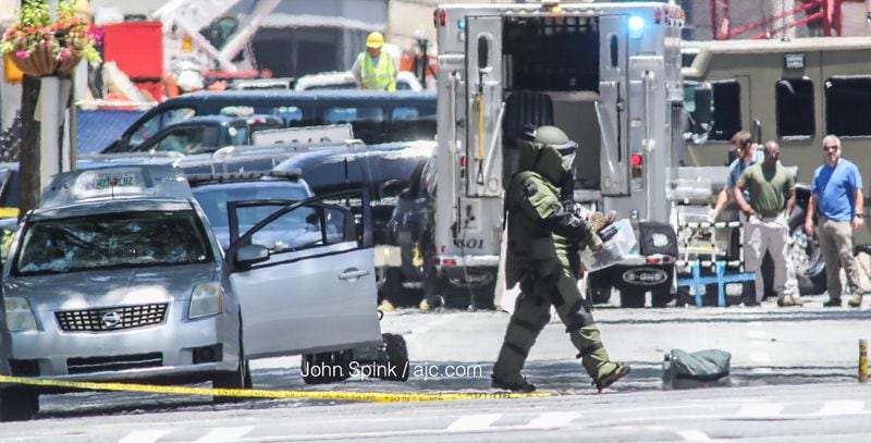 A bomb tech empties a car of all its contents, hours after a disgruntled Air Force veteran set himself on fire Tuesday morning outside the Georgia Capitol. JOHN SPINK / JSPINK@AJC.COM