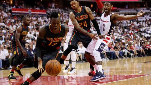 Washington Wizards guard John Wall, right, loses the ball to Atlanta Hawks guard Dennis Schroder, front second from left, during the first half in Game 1 of a first-round NBA basketball playoff series, in Washington, Sunday, April 16, 2017. (AP Photo/Manuel Balce Ceneta)